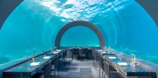 Goście w luksusowej podwodnej restauracji z widokiem na ocean